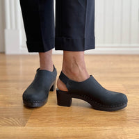 Black slingback clogs from Bryr Studio, showcasing comfort and stylish design indoors